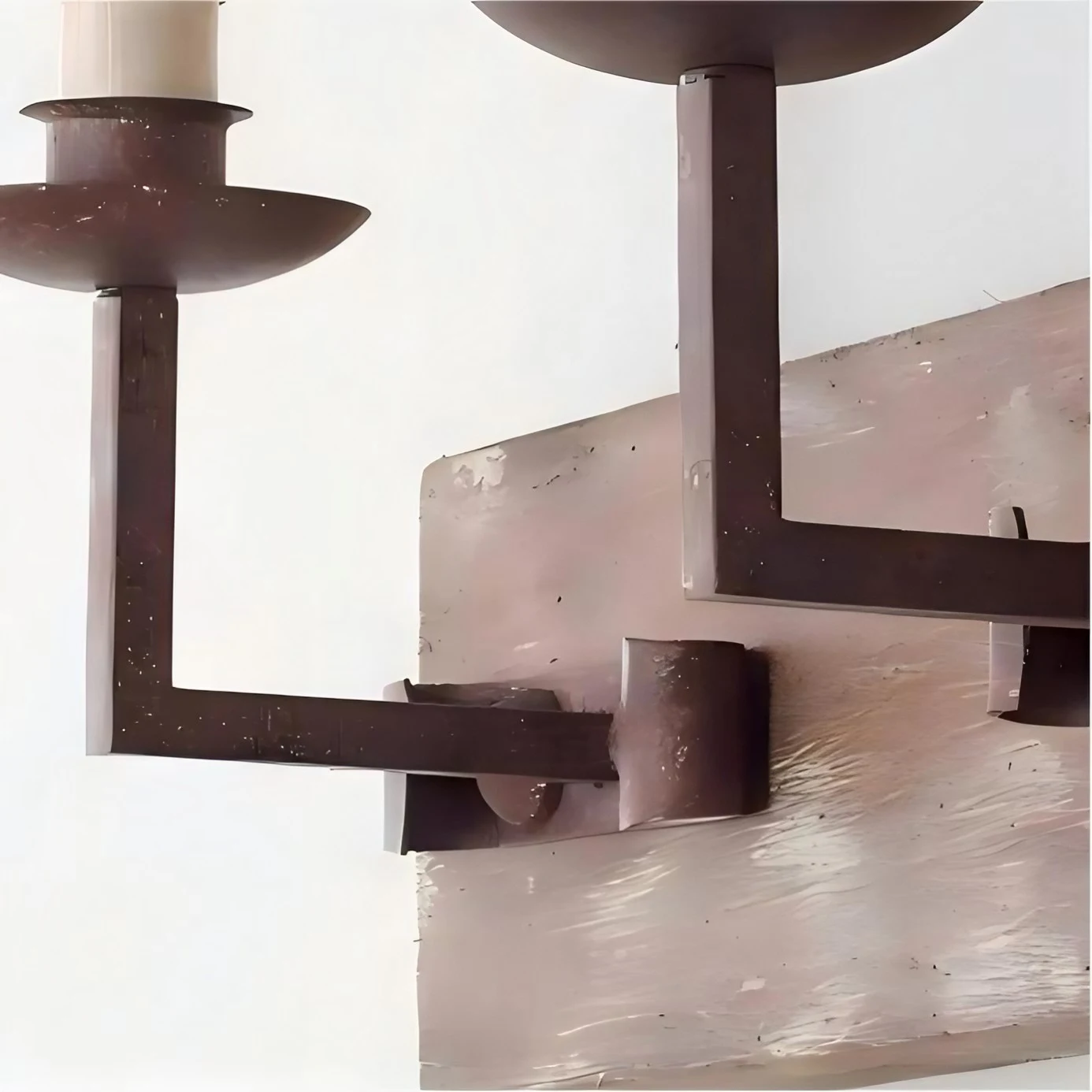Close view of the rustic candle arm and wood backplate