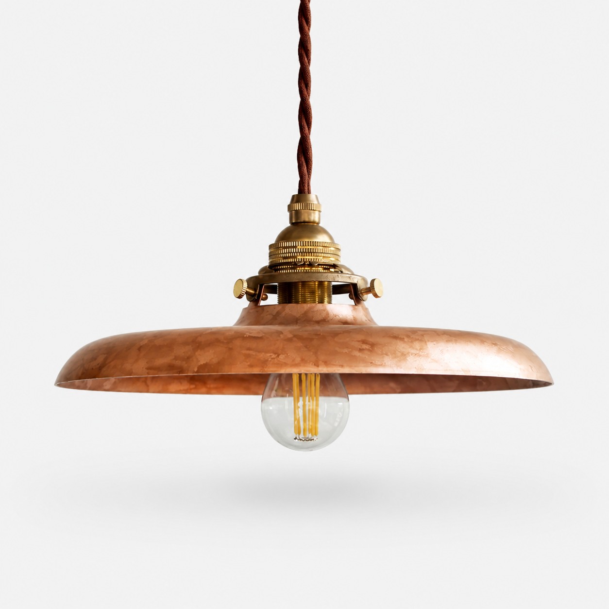 Copper disc pendant shade with exposed bulb